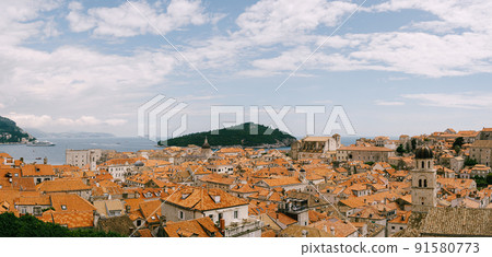 Panoramic view of the whole old city of Dubrovnik. View from the wall to the tiled roofs. Panoramic view of the whole old city of Dubrovnik. View from the wall to the tiled roofs. 91580773