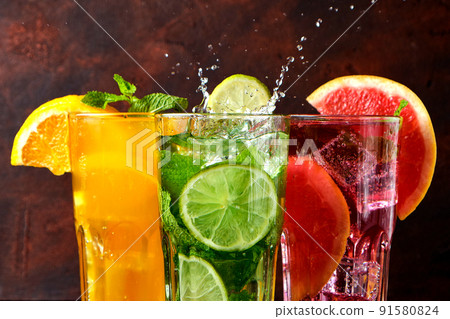 Three classic cocktail glasses on stone black table on dark background. 91580824