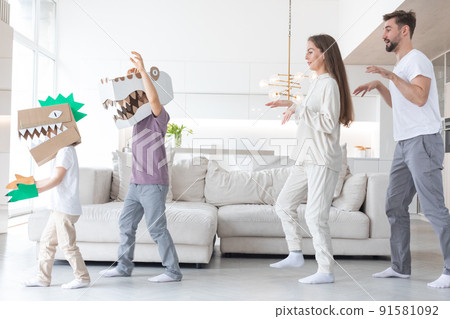 Family playing dinosaurs at home 91581092
