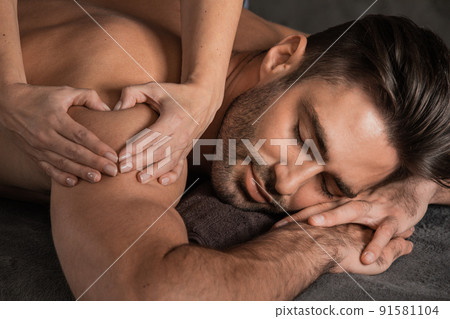 Man getting back massage at spa Man getting back massage at spa 91581104