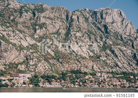 Old stone houses at the foot of the mountain range on the shore of the Bay of Kotor Old stone houses at the foot of the mountain range on the shore of the Bay of Kotor 91581185