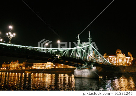 Night illumination of the Freedom Bridge in Budapest 91581245