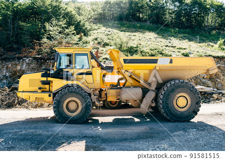 Yellow quarry dump truck standing on the road Yellow quarry dump truck standing on the road 91581515