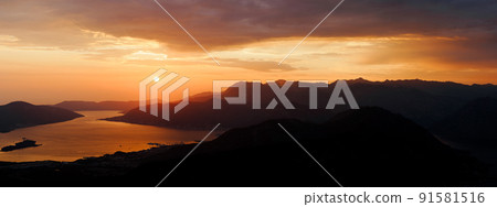 Mountains in the dark against the sunset sky. Mount Lovcen, Montenegro Mountains in the dark against the sunset sky. Mount Lovcen, Montenegro 91581516