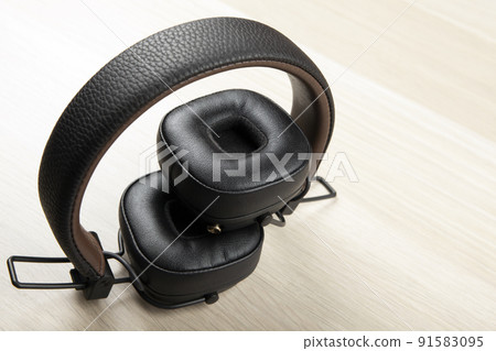 image of headphones wooden desk 91583095