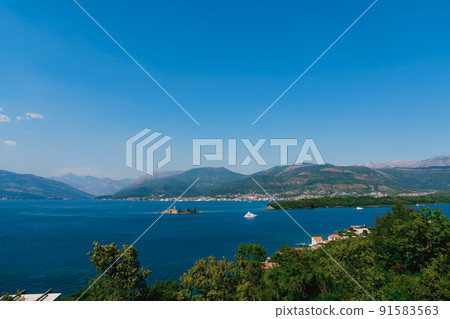 Island of Otocic Gospa in the turquoise bay. Montenegro Island of Otocic Gospa in the turquoise bay. Montenegro 91583563