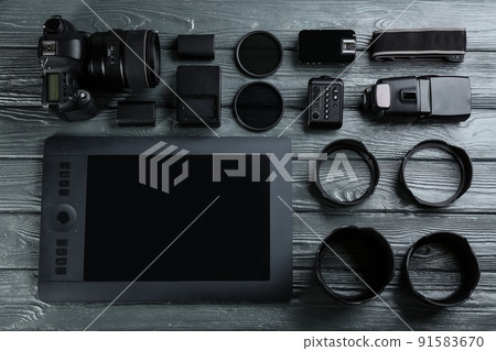 Flat lay composition with equipment for professional photographer on grey wooden table 91583670