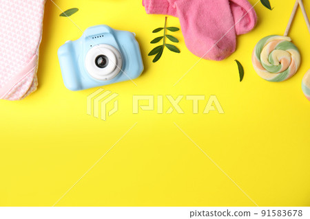 Flat lay composition with toy camera on yellow background, space for text. Future photographer Flat lay composition with toy camera on yellow background, space for text. Future photographer 91583678