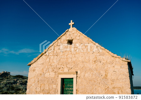 Stone facade of the old Church of St. Ivan at cape Punta Planca 91583872