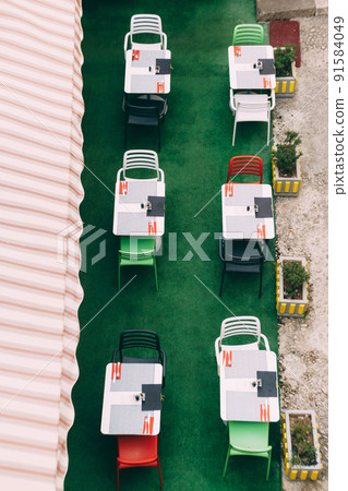 Top view of tables with chairs in a street cafe Top view of tables with chairs in a street cafe 91584049