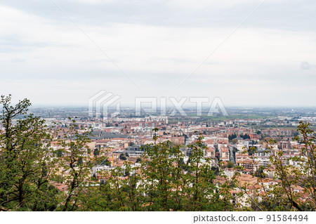 View of Bergamo through thickets of trees. Italy 91584494
