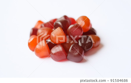 Group of red, orange and purple multivitamin gummies isolated on white background 91584686