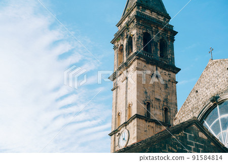Bell tower of the Church of St. Nicholas against the background of a bright blue sky. Montenegro Bell tower of the Church of St. Nicholas against the background of a bright blue sky. Montenegro 91584814