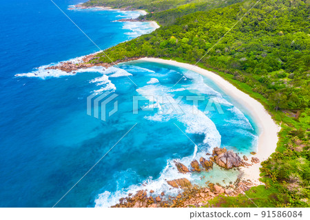 The tropical beach of Anse Cocos, then the beaches of Petit Anse and Grand Anse. La Digue, Seychelles The tropical beach of Anse Cocos, then the beaches of Petit Anse and Grand Anse. La Digue, Seychelles 91586084
