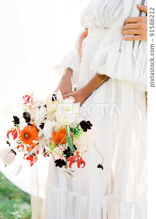 Man hugging woman with bouquet near white curtains 91586212