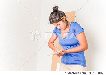 university student moving to first independent apartment. Latin young Bolivian assembly furniture 91587007