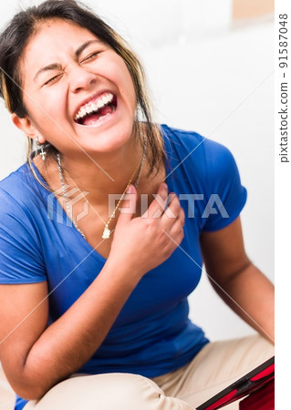 Bolivian young Hispanic woman doing school homework with digital tablet technology 91587048