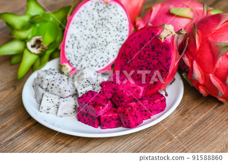 dragon fruit slice and cut half on white plate with pitahaya background , fresh white and red purple dragon fruit tropical in the asian thailand healthy fruit concept 91588860