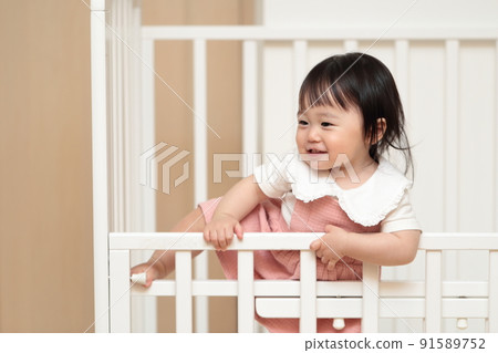 1 year old girl climbing a crib 1 year old girl climbing a crib 91589752