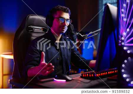 Man Speaking to Mic at Podcast 91589832