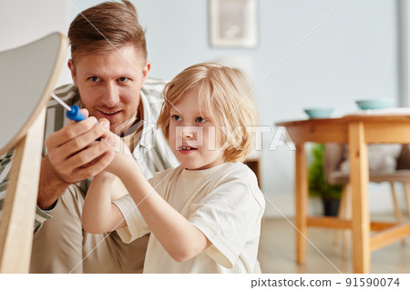 Boy Building Furniture with Dad 91590074