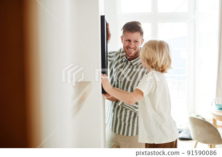 Father and Son Hanging Picture Back View Father and Son Hanging Picture Back View 91590086