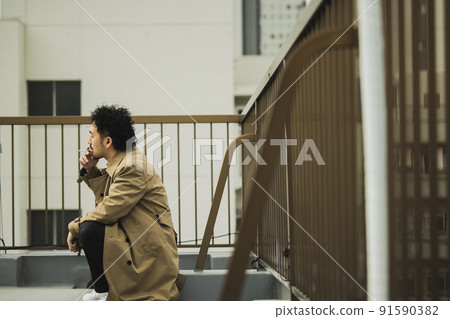 A bearded man in a trench coat that looks like a police drama A bearded man in a trench coat that looks like a police drama 91590382