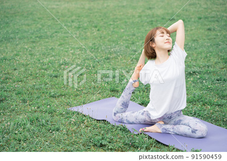 Park yoga half pigeon pose Park yoga half pigeon pose 91590459