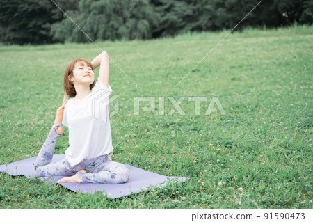 Park yoga half pigeon pose 91590473