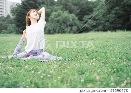 Park yoga half pigeon pose 91590478