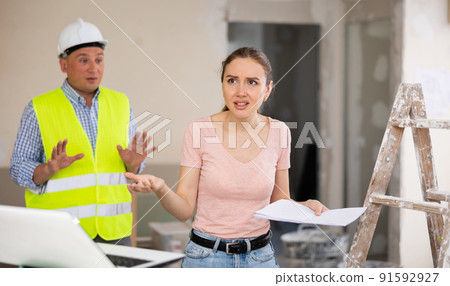 Disappointed woman construction manager inspecting apartment 91592927