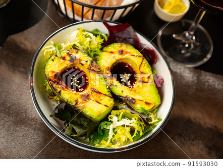 Grilled avocado with ponzu sauce and greens 91593030