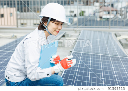 Female worker inspecting solar panels Female worker inspecting solar panels 91593513