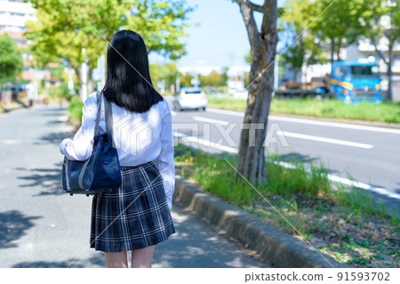 Back view of high school girls going to school in the city, going to and from school, no face 91593702
