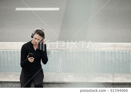 Woman listening to music during training 91594066