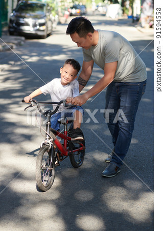 Boy Learning Riding Bicycle 91594558