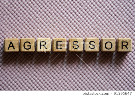 Aggressor word collected with wooden cubes on light background Aggressor word collected with wooden cubes on light background 91595647