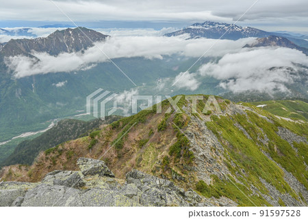 Fresh green Northern Alps seen from the ridgeline of the Japanese Alps Kamikochi, Mt. Yake and Mt. Norikura in Nagano Prefecture Fresh green Northern Alps seen from the ridgeline of the Japanese Alps Kamikochi, Mt. Yake and Mt. Norikura in Nagano Prefecture 91597528