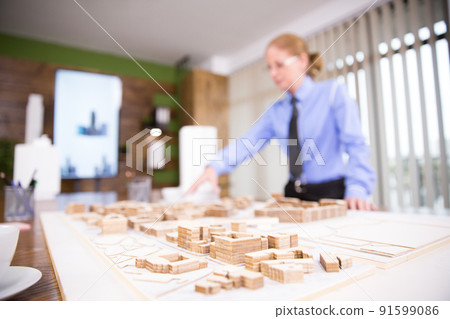 Close up of female architect working on real estate project. Mini town. Close up of female architect working on real estate project. Mini town. 91599086