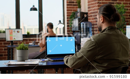 Company employee working on laptop with greenscreen, using isolated chroma key template on computer. Analyzing blank mockup background with copy space and pc display, business freelancer. Company employee working on laptop with greenscreen, using isolated chroma key template on computer. Analyzing blank mockup background with copy space and pc display, business freelancer. 91599180