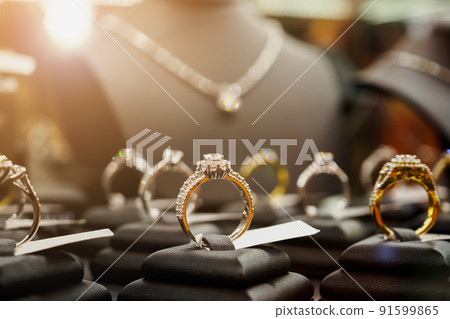 Jewelry diamond rings and necklaces show in luxury retail store window display 91599865