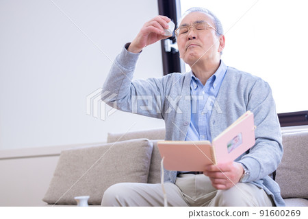 爺爺一邊喝酒一邊看著孫子的照片 91600269