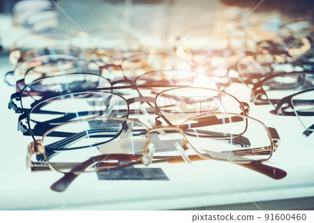 Eye glasses on window display shelves in optics store Eye glasses on window display shelves in optics store 91600460