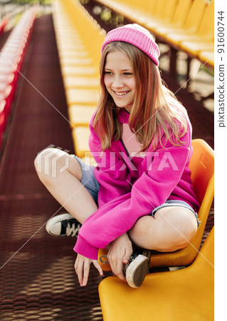 Portrait of a charming girl sitting on the school bleachers during a break 91600744