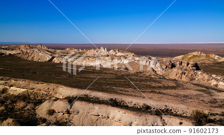 Panorama view to Aral sea from the rim of Plateau Ustyurt at sunset , Karakalpakstan, Uzbekistan Panorama view to Aral sea from the rim of Plateau Ustyurt at sunset , Karakalpakstan, Uzbekistan 91602173