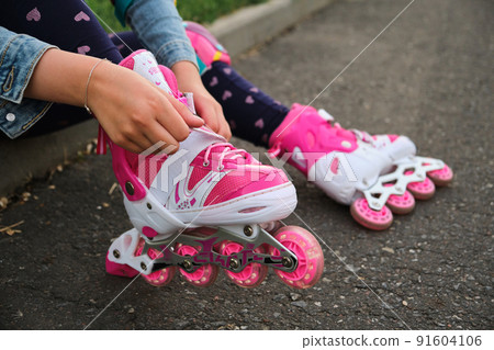 Close-up Of Legs Wearing Roller Skating Shoe, Outdoors Close-up Of Legs Wearing Roller Skating Shoe, Outdoors 91604106