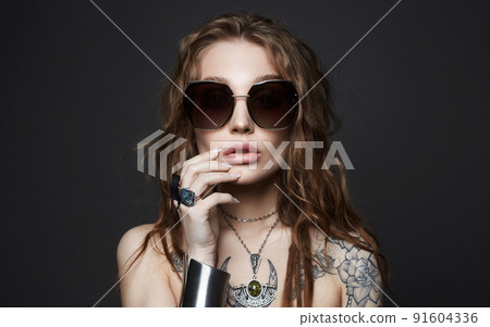 portrait of Beautiful sexy woman with tattoo. beauty tattooed girl in sunglasses 91604336
