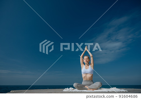 Yoga practice and meditation in nature. Woman practicing near Black sea. Yoga practice and meditation in nature. Woman practicing near Black sea. 91604686