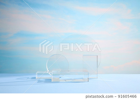 Front view of transparent podium decorated in blue cloudy background Front view of transparent podium decorated in blue cloudy background 91605466