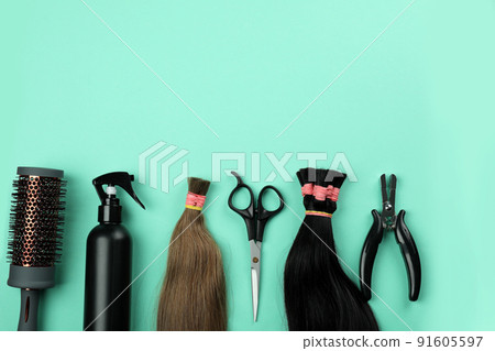 Composition with hair extension accessories on mint background 91605597